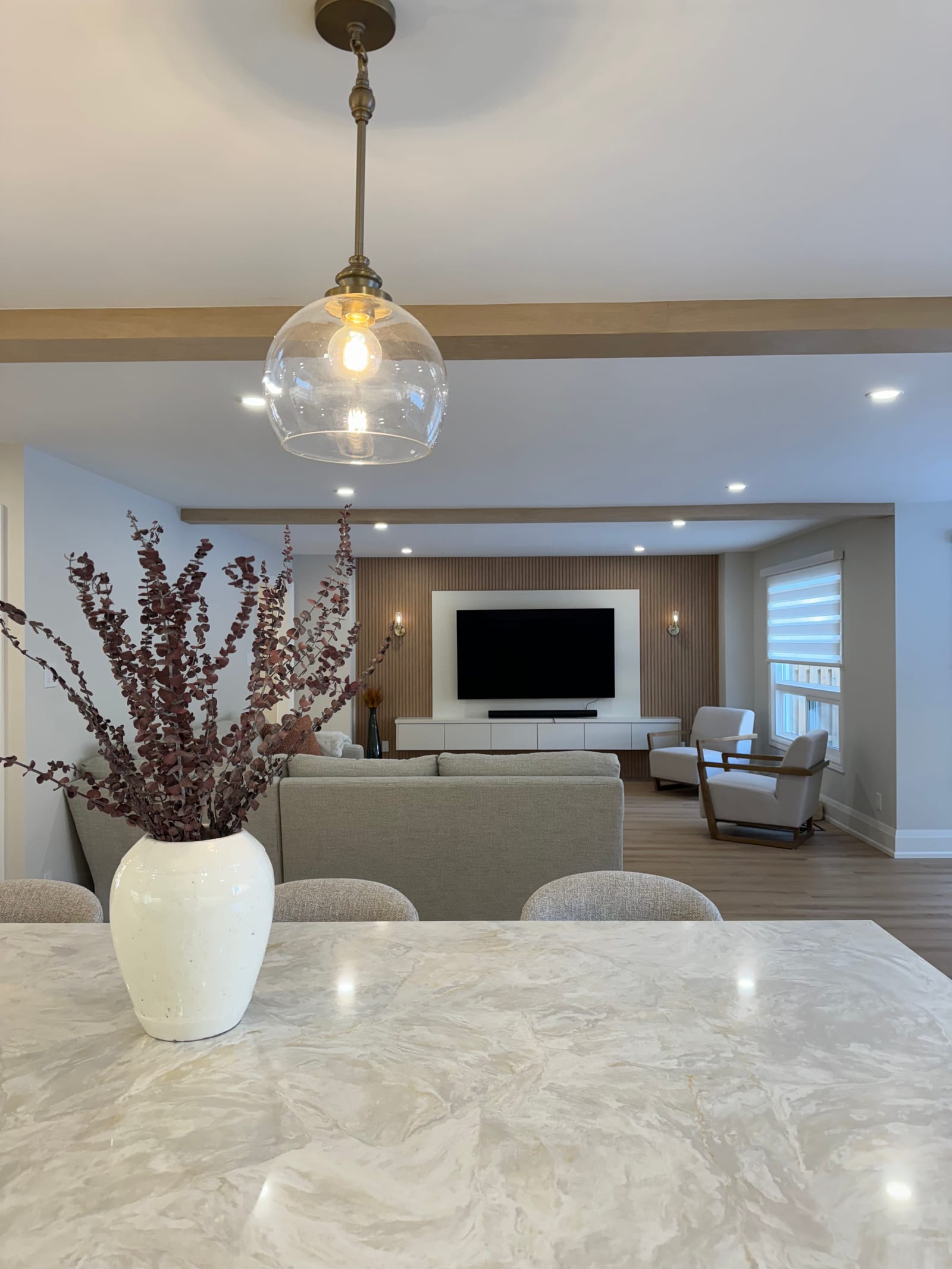 View from the island across the family room to a slatted oak media wall