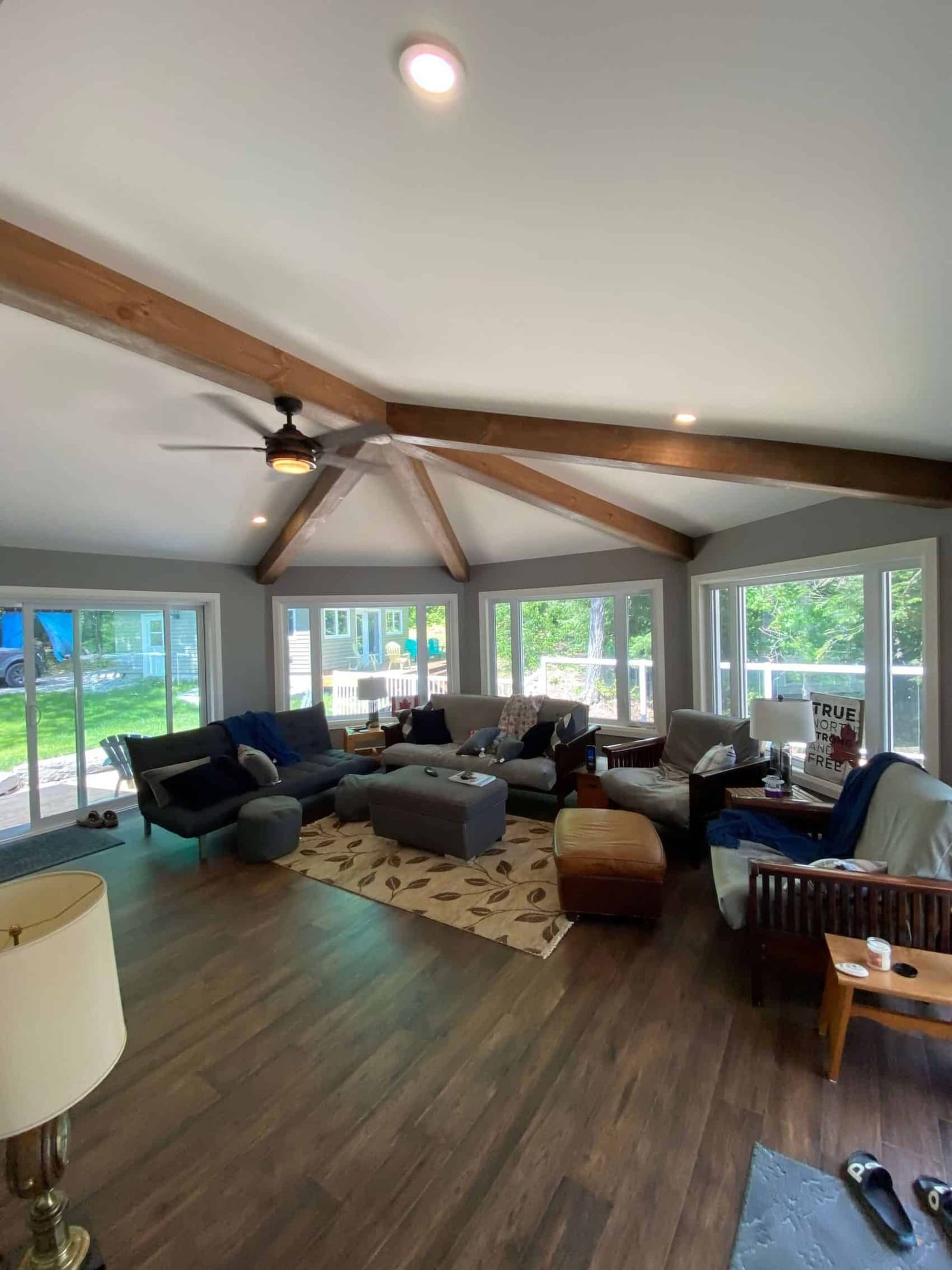 A bright room with timber collar beams and windows on three sides