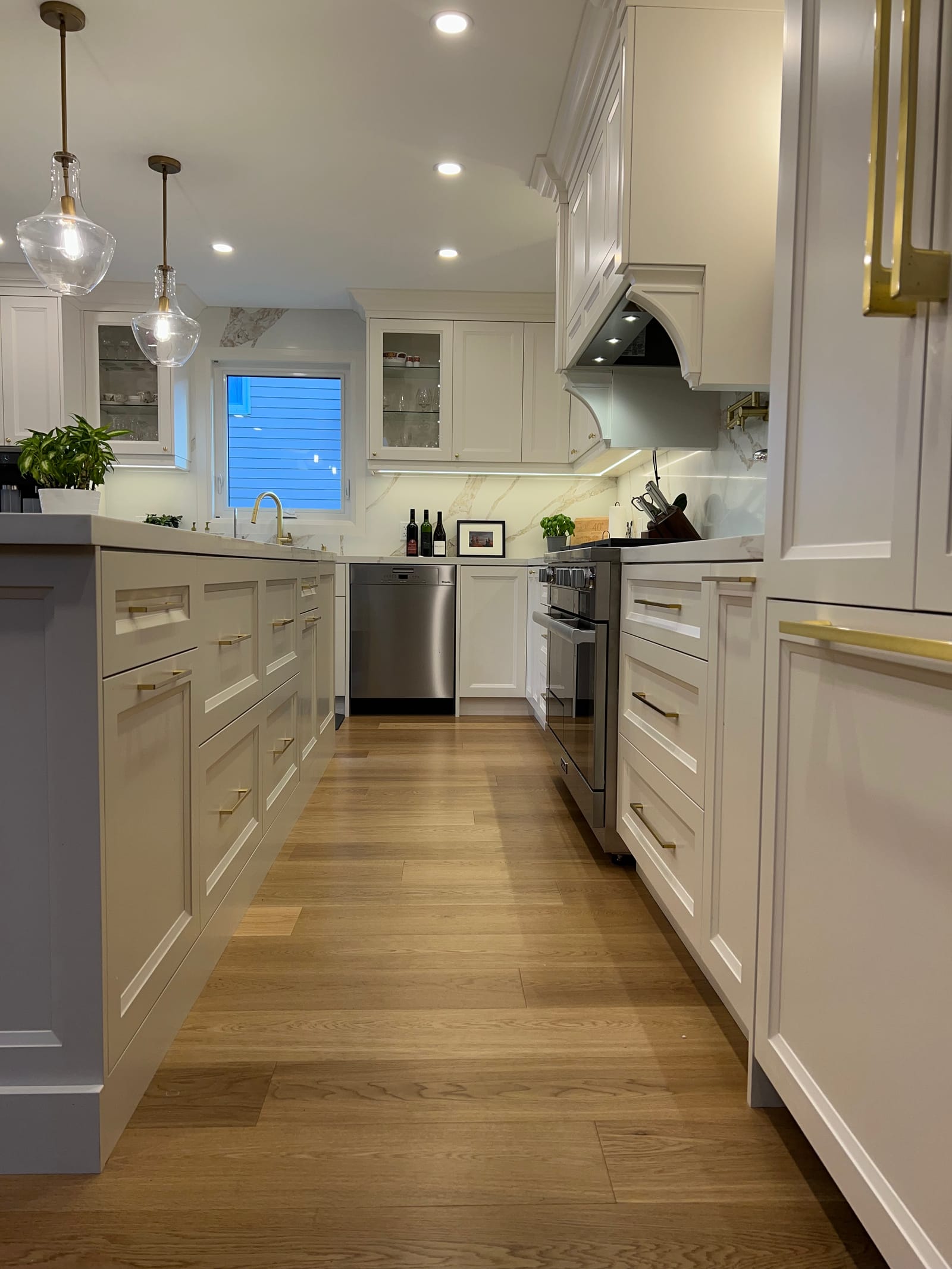 A low view down the kitchen between the island and the range wall